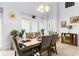 Dining room with a wooden table, six chairs, and decor at 235 Hollingshead Loop, Davenport, FL 33896