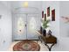 Inviting foyer with double doors, console table, decor, and tile flooring at 235 Hollingshead Loop, Davenport, FL 33896