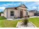 Charming single-story home with landscaped front yard, columns, and a two-car garage at 235 Hollingshead Loop, Davenport, FL 33896