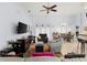 Bright and open living room with a ceiling fan, neutral paint, and tile flooring at 235 Hollingshead Loop, Davenport, FL 33896