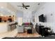 Spacious living room with open floor plan, ceiling fan, tile flooring, and natural light at 235 Hollingshead Loop, Davenport, FL 33896