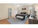 Main bedroom featuring wood floors, walk-in closet, and two windows at 235 Hollingshead Loop, Davenport, FL 33896