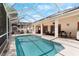 Lovely screened-in pool with covered lanai and ample seating at 235 Hollingshead Loop, Davenport, FL 33896