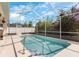 Inviting screened-in pool area surrounded by lush landscaping at 235 Hollingshead Loop, Davenport, FL 33896