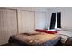 Cozy bedroom with multiple closets and window with dark curtains at 25618 Fishermans Rd, Paisley, FL 32767