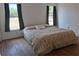 Bedroom features hardwood floors, natural light, and a comfortable queen size bed at 25618 Fishermans Rd, Paisley, FL 32767