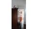 Hallway view of wooden cabinet and doorway leading to bathroom at 25618 Fishermans Rd, Paisley, FL 32767