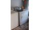 Laundry room featuring a white washer and dryer with tile flooring at 25618 Fishermans Rd, Paisley, FL 32767