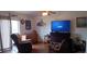 Cozy living room featuring hardwood floors, comfortable seating, and a large screen television at 25618 Fishermans Rd, Paisley, FL 32767