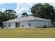 Spacious backyard featuring a well-maintained lawn and a cozy patio area at 25618 Fishermans Rd, Paisley, FL 32767