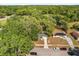 An aerial view of a single Gathering home with a driveway and an abundance of surrounding trees at 2935 Arcata Ln, Orlando, FL 32817