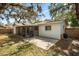 Wide view of the backyard showing a covered patio, concrete patio and grass at 2935 Arcata Ln, Orlando, FL 32817