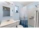 Bathroom features a shower, sink, toilet, mirror and a window with house plant at 2935 Arcata Ln, Orlando, FL 32817