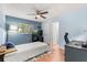 Comfortable bedroom with wood floors, a ceiling fan and natural light from a window at 2935 Arcata Ln, Orlando, FL 32817