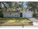 Charming single-story home with well-maintained lawn, blue door, and a one car garage at 2935 Arcata Ln, Orlando, FL 32817
