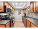 Efficient kitchen with stainless steel appliances, wood cabinets and a skylight at 2935 Arcata Ln, Orlando, FL 32817