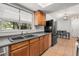 Bright kitchen features stone countertops, wood cabinetry and stainless steel refrigerator at 2935 Arcata Ln, Orlando, FL 32817