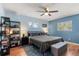 Relaxing main bedroom with a ceiling fan, natural light, and a comfortable bed at 2935 Arcata Ln, Orlando, FL 32817