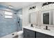 Updated bathroom featuring a double sink vanity and a tiled walk-in shower at 307 Coble Dr, Longwood, FL 32779