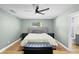 Serene bedroom with wood floors, upholstered headboard, and neutral paint at 307 Coble Dr, Longwood, FL 32779