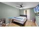 Tranquil bedroom featuring comfortable bed, ceiling fan, and natural light at 307 Coble Dr, Longwood, FL 32779