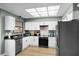 Modern kitchen with stainless steel appliances, white cabinets, and sleek countertop at 307 Coble Dr, Longwood, FL 32779