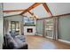 Cozy living room featuring a brick fireplace and exposed beam ceiling at 307 Coble Dr, Longwood, FL 32779