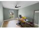 Bright room with wood floors, a modern ceiling fan, and large window at 307 Coble Dr, Longwood, FL 32779
