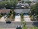 Aerial front view of property and neighboring community with mature trees at 3154 Stonecastle Rd, Orlando, FL 32822