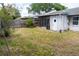 Backyard showing fencing, sparse grass, and access to a screened-in enclosure at 3154 Stonecastle Rd, Orlando, FL 32822