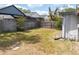 Fenced backyard with a mix of green and brown grass, showcasing the outdoor space at 3154 Stonecastle Rd, Orlando, FL 32822