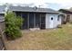 View of a fenced backyard featuring a screened-in porch and some landscaping at 3154 Stonecastle Rd, Orlando, FL 32822