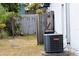 Fenced backyard featuring an updated air conditioning unit and limited landscaping at 3154 Stonecastle Rd, Orlando, FL 32822