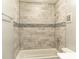 Bathroom with modern tile, shower, and tub combination, providing a clean, contemporary feel at 3154 Stonecastle Rd, Orlando, FL 32822