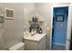 Bathroom with sleek vanity, open shelving, and ample lighting from a large mirror at 3154 Stonecastle Rd, Orlando, FL 32822