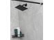 A close-up of the bathroom's shower head and a shelf holding shampoo bottles in a renovated bathroom at 3154 Stonecastle Rd, Orlando, FL 32822