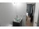 The remodeled bathroom features a modern glass vessel sink atop a black cabinet, with a bedroom visible in the background at 3154 Stonecastle Rd, Orlando, FL 32822