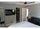 Cozy bedroom with a ceiling fan, TV, walk-in closet, and ensuite bathroom at 3154 Stonecastle Rd, Orlando, FL 32822