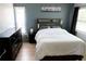 Bright bedroom with a neutral color scheme, wood floors, ceiling fan and large windows at 3154 Stonecastle Rd, Orlando, FL 32822