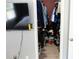 A walk-in closet featuring laminate wood flooring, filled with clothing and shoes and a television mounted nearby at 3154 Stonecastle Rd, Orlando, FL 32822