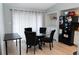 Bright dining area with modern table, chairs, and a view of the laundry area through a doorway at 3154 Stonecastle Rd, Orlando, FL 32822