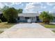 The exterior of a single story home showing the front, driveway, and some landscaping at 3154 Stonecastle Rd, Orlando, FL 32822