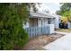 The exterior of a single story home with a small, fenced front yard and trees nearby at 3154 Stonecastle Rd, Orlando, FL 32822