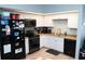 Well-lit kitchen features white cabinetry, black appliances, and a stainless steel sink at 3154 Stonecastle Rd, Orlando, FL 32822