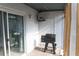 Covered patio featuring a pellet grill, sliding glass doors, and hanging storage at 3154 Stonecastle Rd, Orlando, FL 32822