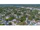 Expansive aerial view of a residential neighborhood with mature trees and a nearby lake offering a serene setting at 3199 Tobago Ct, Apopka, FL 32703