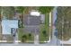 An aerial view of a home with a swimming pool, mature trees, and established landscaping at 3199 Tobago Ct, Apopka, FL 32703