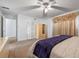 Bedroom featuring neutral carpet, a bed with a purple throw, and a ceiling fan at 3199 Tobago Ct, Apopka, FL 32703