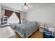 Bedroom with a ceiling fan, window with curtains, and bed with blue patterned bedding at 3199 Tobago Ct, Apopka, FL 32703
