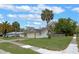Single-story home featuring a one-car garage, driveway, and a well-maintained front lawn with palm trees at 3199 Tobago Ct, Apopka, FL 32703